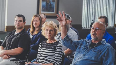 man raising hand for question