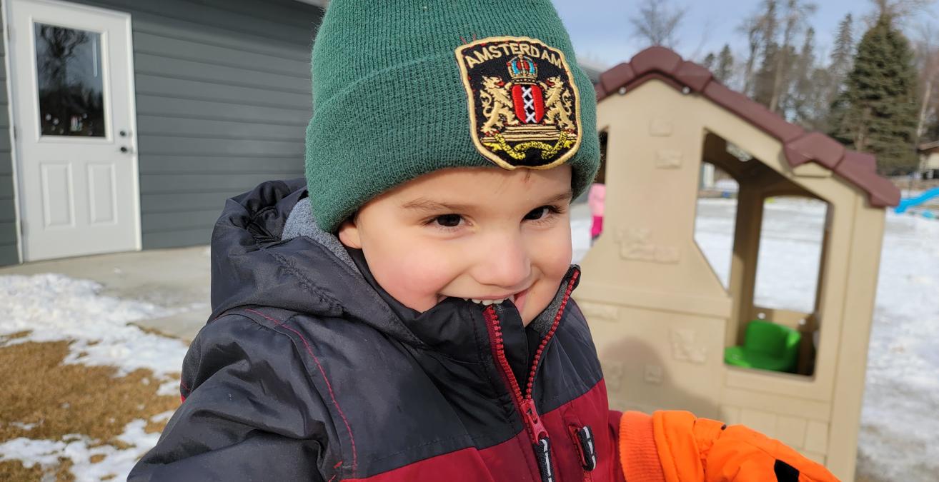 toddler on slide in winter